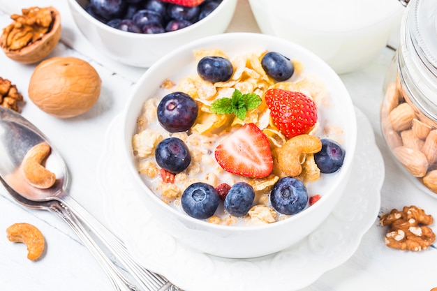 crunchy flakes with blueberries and various yogurts for healthy breakfast, close-up