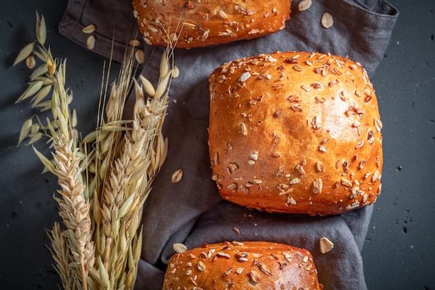 Crunchy and fresh oat buns baked in rustic kitchen