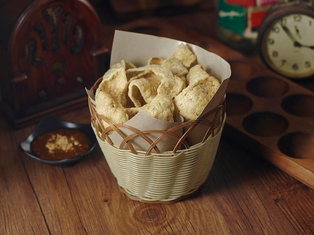 Crunchy Keropok with chili sauce served in basket isolated on table top view of thai food