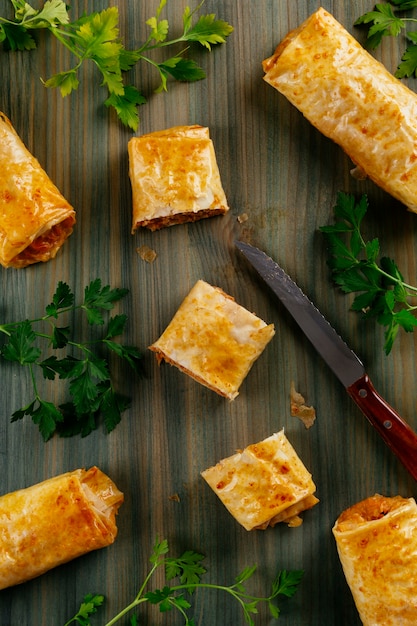 Crunchy phyllo dough roll filled with tuna cut into pieces to share