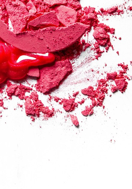 Crushed eyeshadows lipstick and powder isolated on white background