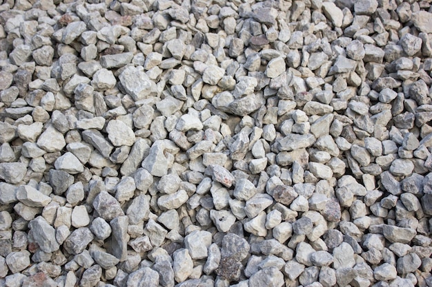 Crushed rocky granite Crushed stone construction Middle fraction of stone building stoneBackground texture