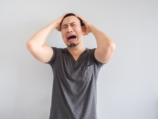 Crying asian man in black t-shirt.