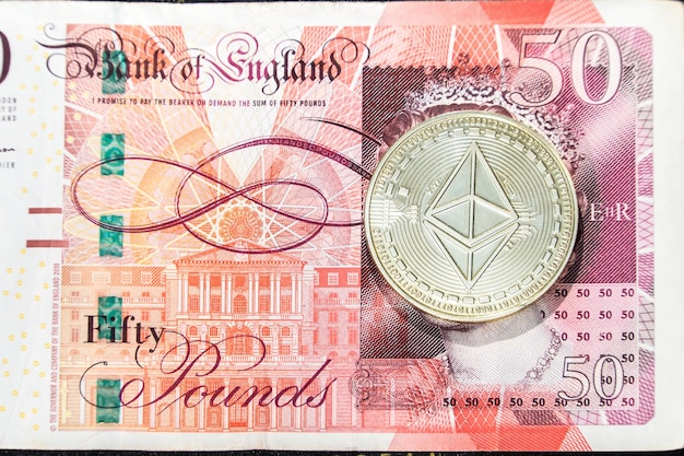 Cryptocurrency Ethereum on the United Kingdom's queen's face on a 50 pound sterling note