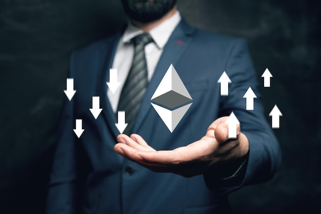 Cryptocurrency icon with up and down arrows Man holding in his hand