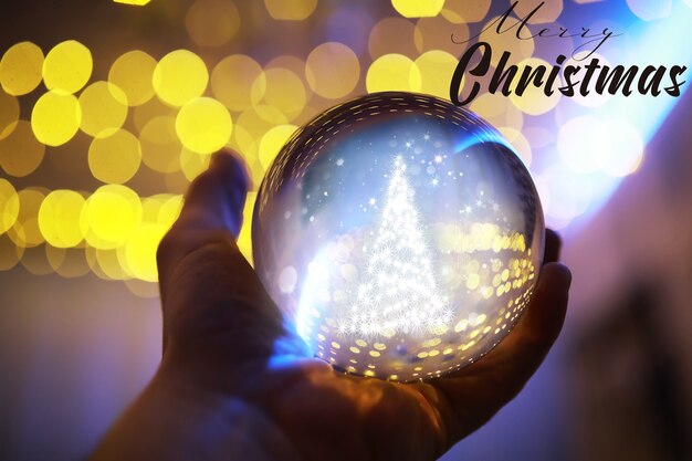 Photo crystal ball on the floor with bokeh, lights behind. glass ball with colorful bokeh light, new year celebration concept.