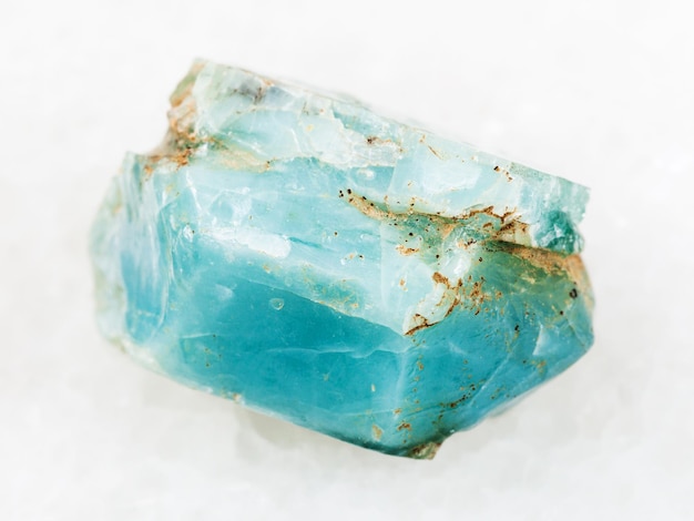 Crystal of blue apatite gemstone on white