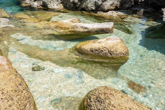 Crystal clear sea waters with rocks at the bottom of the sea Daytime long exposurexD