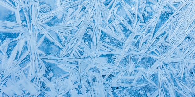 Crystalline patterns dance across the cool expanse of the blue ice texture