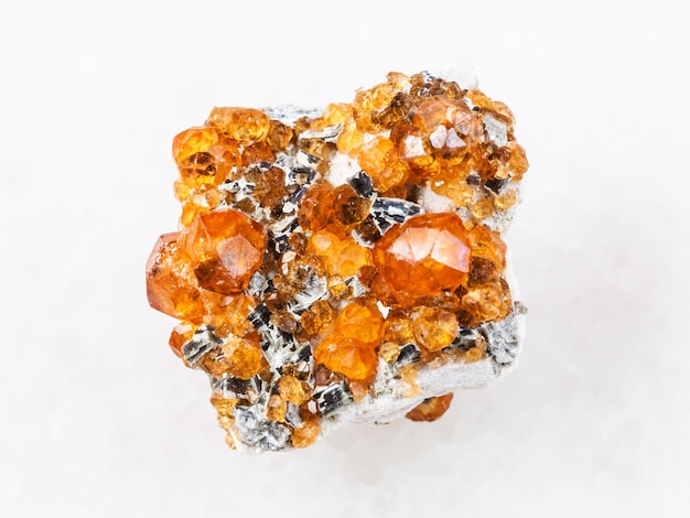 Crystals of spessartine garnet gemstone on white