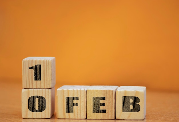 Cube shape calendar for February 10 on wooden surface with empty space for text new year