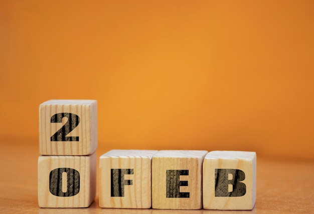 Cube shape calendar for february 20 on wooden surface with empty space for text new year Wooden calendar with date February cube calendar on wooden surface with copy space