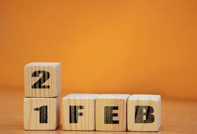 Cube shape calendar for february 21 on wooden surface with empty space for text new year Wooden calendar with date February cube calendar on wooden surface with copy space