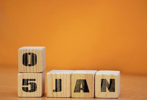 Cube shape calendar for January 05 on wooden surface with empty space for text new year Wooden calendar with date January cube calendar on wooden surface with copy space