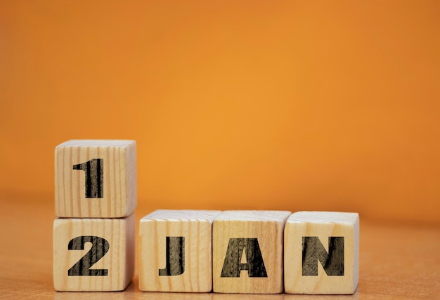 Cube shape calendar for January 12 on wooden surface with empty space for text new year Wooden calendar with date January cube calendar on wooden surface with copy space