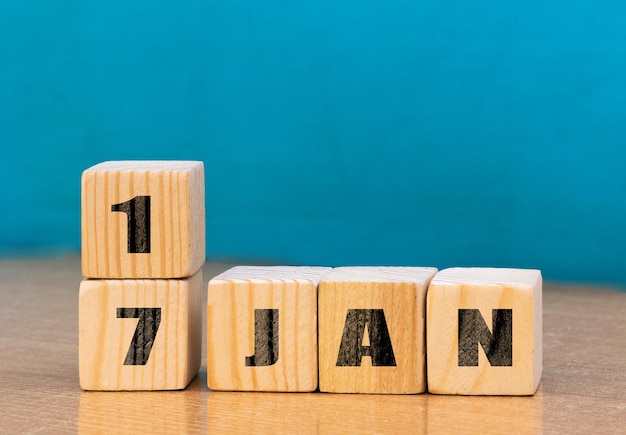 Cube shape calendar for January 17 on wooden surface with empty space for textcube calendar for January on wood background