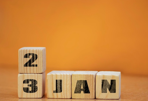 Cube shape calendar for January 23 on wooden surface with empty space for text new year Wooden calendar with date January cube calendar on wooden surface with copy space