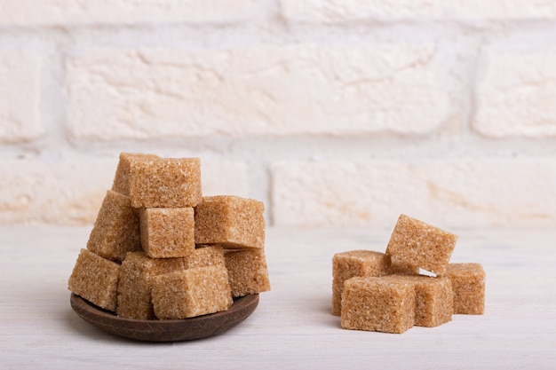 Cubes of cane sugar in a wooden spoon