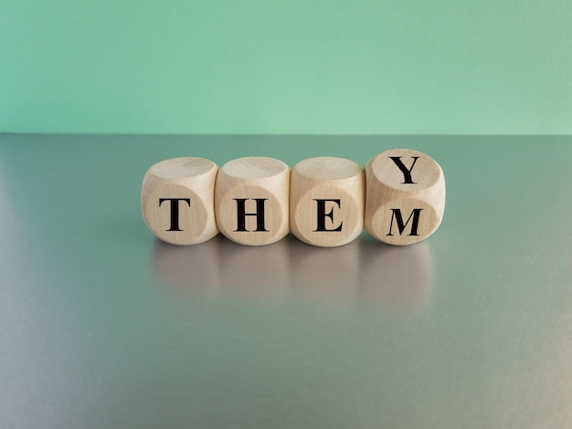 Photo cubes form gender neutral pronouns they and them beautiful blue background grey table copy space