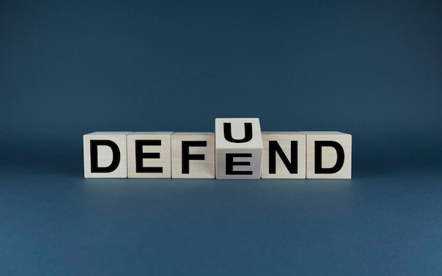 Cubes form words Defund or Defend Defund and Defend concept