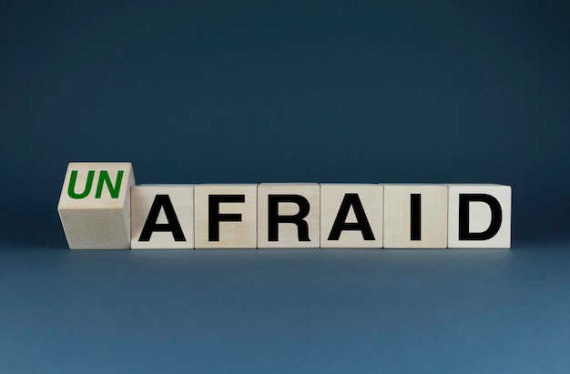 Cubes form the words Un afraid or afraid Concept in business and lifestyle