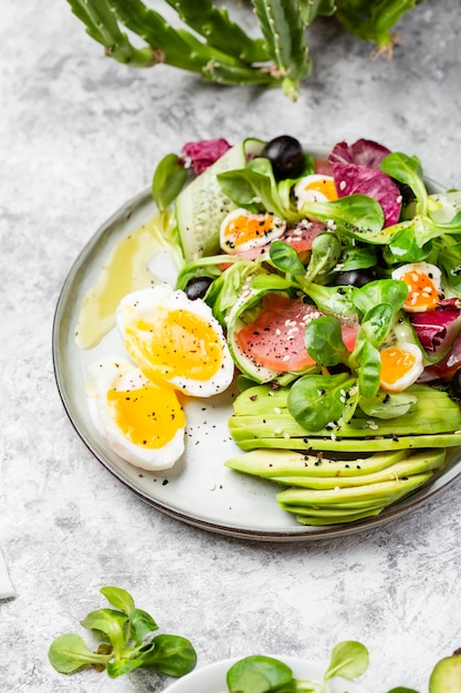 Cucumber, smoked tuna and avocado salad with egg and olives