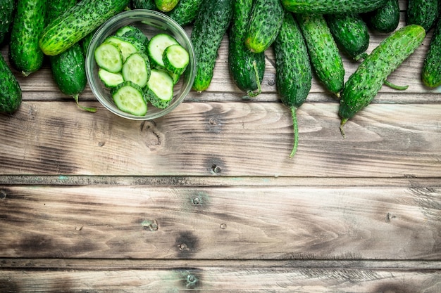 Cucumbers and cucumber slices in a glass bowl