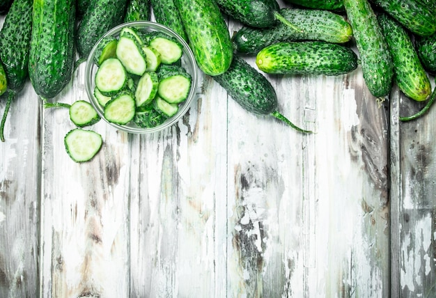 Cucumbers and cucumber slices in a glass bowl