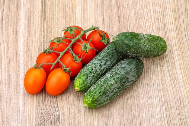 Cucumbers and tomatoes on the branch