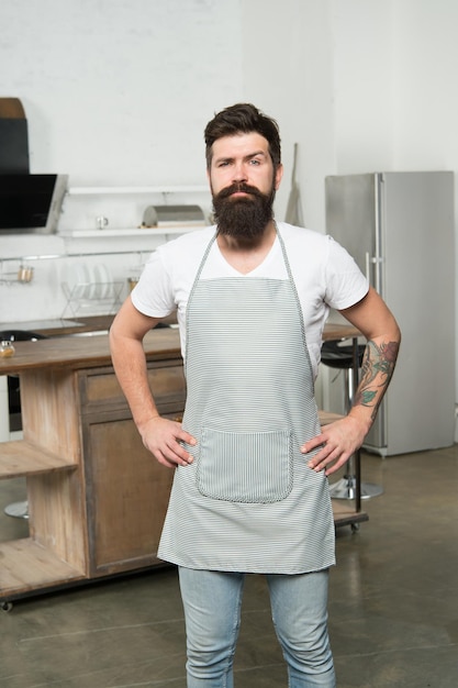 Cuisine for real men Cooking tasty food at home Home food Recommend nice recipe Culinary business Brutal confident chef in restaurant Hipster bearded masculine chef cooking food in kitchen