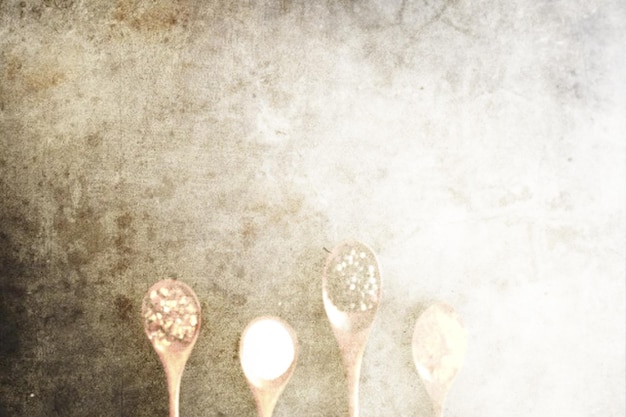 Culinary background A sheet of paper with a transparent pattern of wooden spoons with spices and seasonings