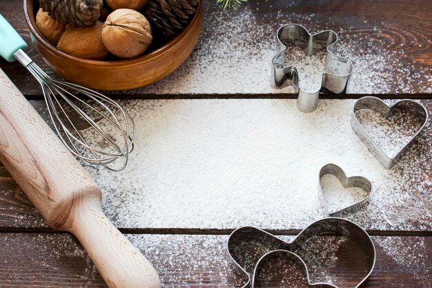 Culinary background with flour and shapes for Christmas cookies with a place for text