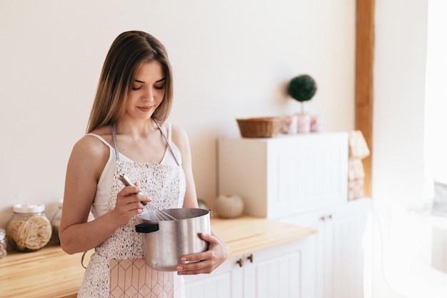 Culinary Blog of a Young Woman Saucepan and Whisk in the Hands of a Cute Girl