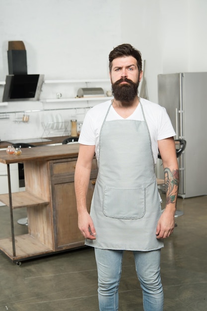 Culinary business Brutal confident chef in restaurant Hipster bearded masculine chef cooking food in kitchen Cuisine for real men Cooking tasty food at home Home food Recommend nice recipe