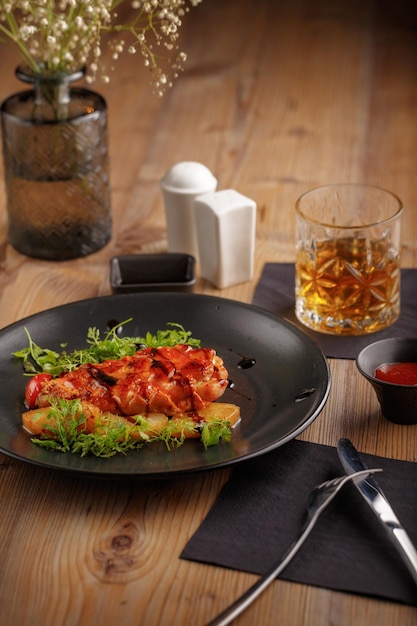 Culinary dish chicken steak restaurant serving black tableware wooden table