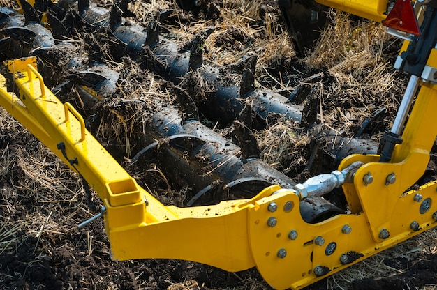 Cultivator at work, close up of fragment of deep ripper