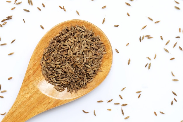 Cumin or caraway seeds on white surface. Top view