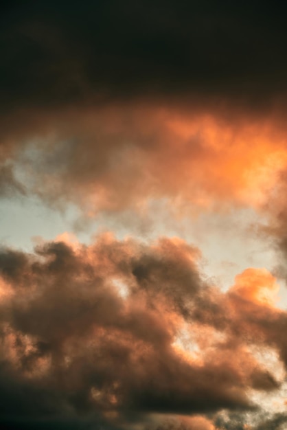 Cumulus sunset clouds with the sun setting down Amazing sky summer evening background