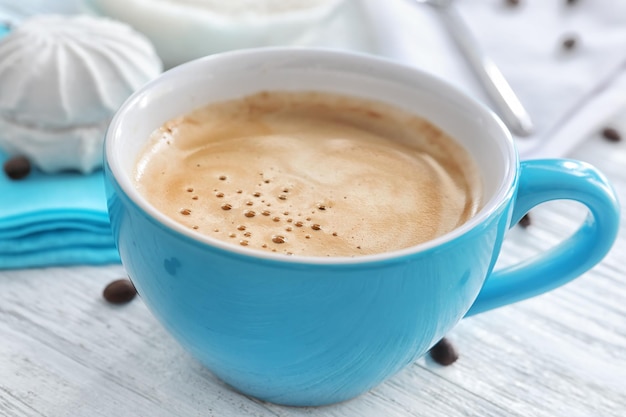 Cup of aromatic morning coffee on wooden table