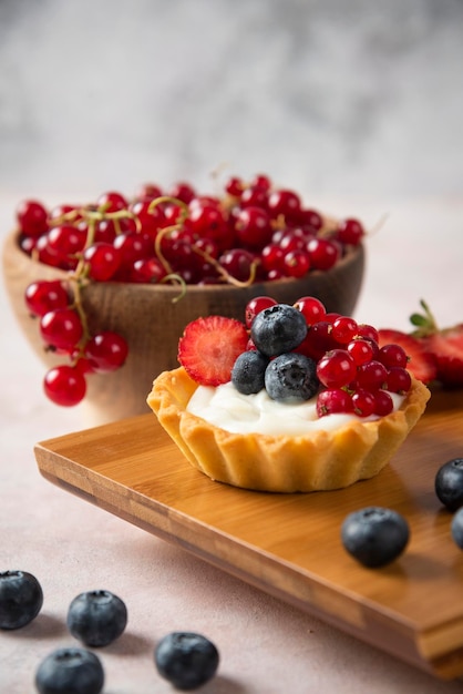 Cup cakes on white backround with wooden plate