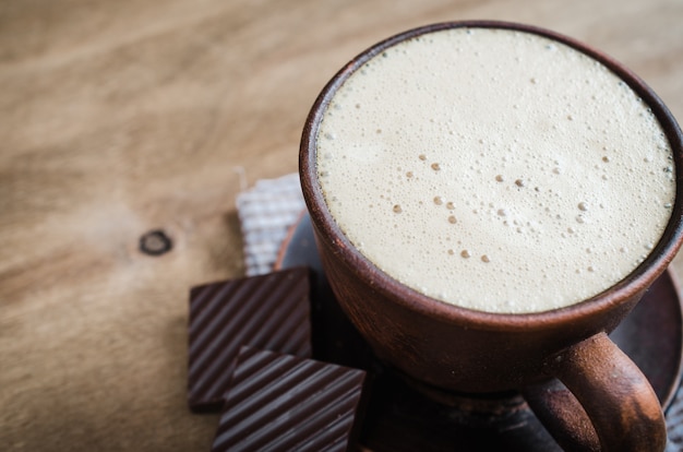 Cup of Cappuccino With a Piece of Chocolate.