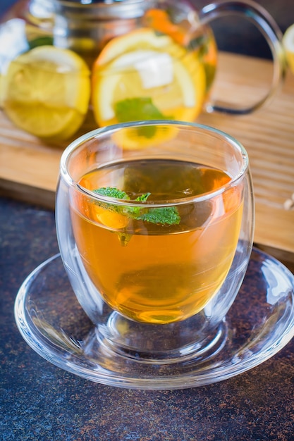 Cup of Citrus tea on blue stone table. Still life. Drink Healthcare Cold Concept