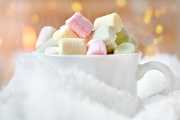 Cup of cocoa and marshmallows on a light background