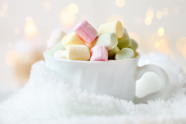 Cup of cocoa and marshmallows on a light background