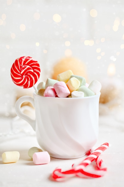 Cup of cocoa and marshmallows on a light background