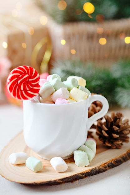 Cup of cocoa and marshmallows on a light background