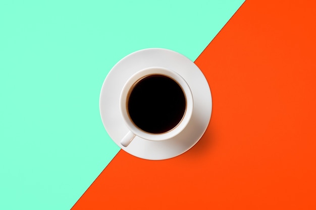 Cup of coffee on a background of Lush Lava and Aqua Menthe color