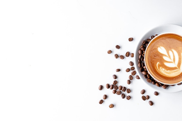 Cup of coffee and bean on white table background top view