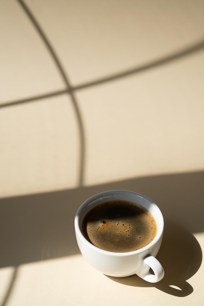 Cup of coffee on beige studio background