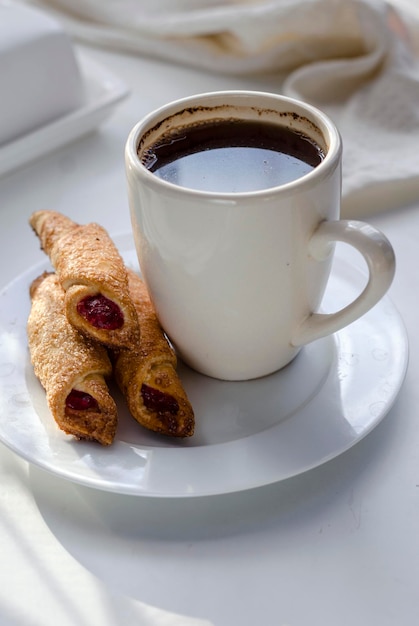 Cup of coffee and biscuits with jam